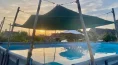 DIY pool shelter with a canvas tarp